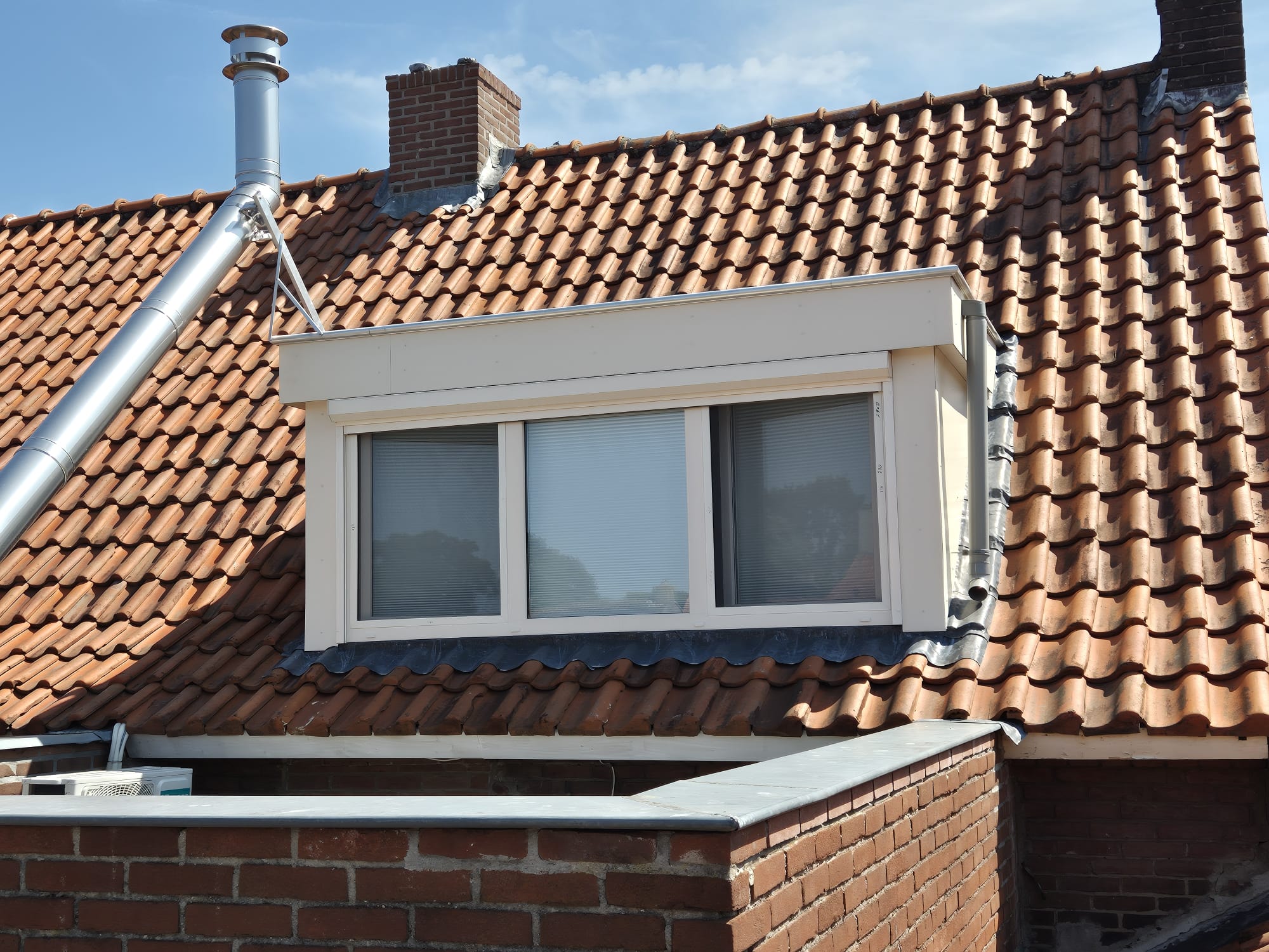 Dakkapel dormer window installation on tiled roof in Nuenen